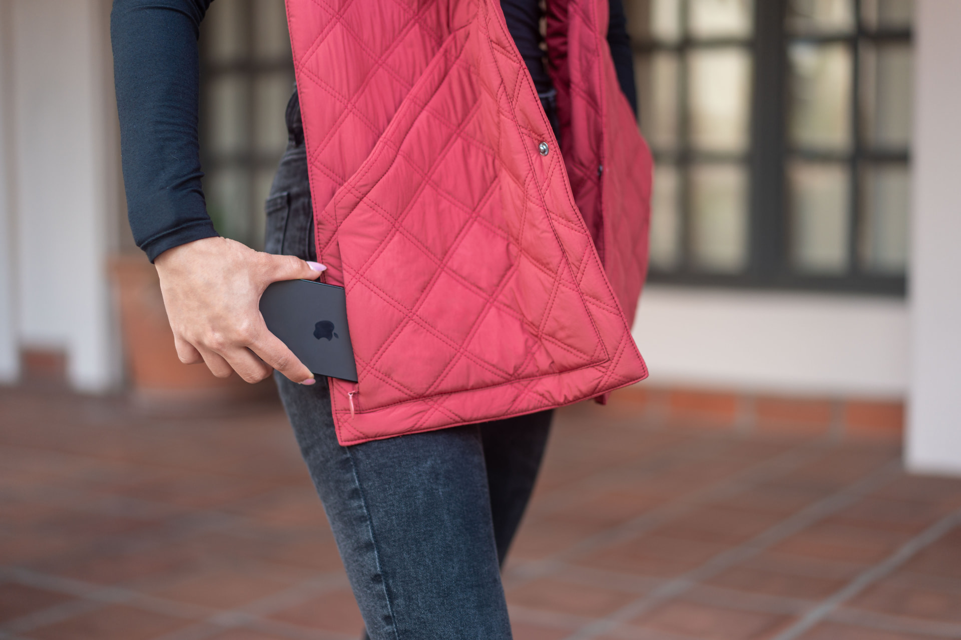 Slipping a phone into the pocket of the red 418 Scarf
